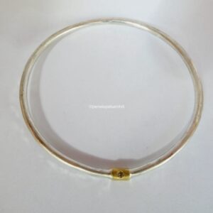It's a wrap bangle; 3mm sterling silver, 24ct gold and 2.3mm E SI diamond. Internal diameter 66mm