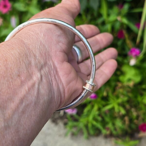 Roller Bangle; 3.5mm solid silver with 9ct red gold and silver. Internal diameter 64mm