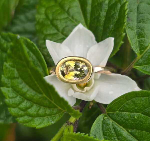 Green tourmaline empress ring with pink sapphire; silver, 18ct pink and 24ct gold. Size M .