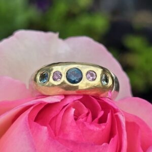 Eclipse ring; 18ct green gold and silver set with pink and green sapphires. Size Q