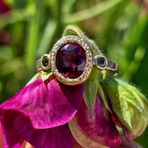 Chloris ring; 9x7mm red zircon, unheated green sapphires, fine silver, 18ct pink gold. Size P 1/2