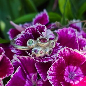 Lovers Knot ring; tourmaline, sapphires, tsavorite garnet, silver. Size N