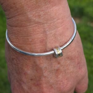 Roller bangle, 3mm silver with silver and 18ct gold. Internal diameter 62mm