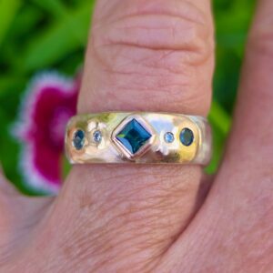 Eclipse ring; 9ct and 18ct red and pink gold, silver, green sapphires and diamonds.