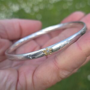 Bright star bangle, solid oval silver 5mm x 3mm, 24ct gold, four natural white diamonds SI E grade. Inner diameter 61mm