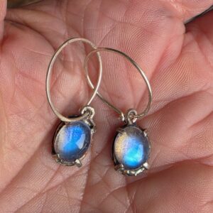 Blue moonstone hoop earrings. Gems measure 10x8mm, hoops 18mm diameter. One pair only.